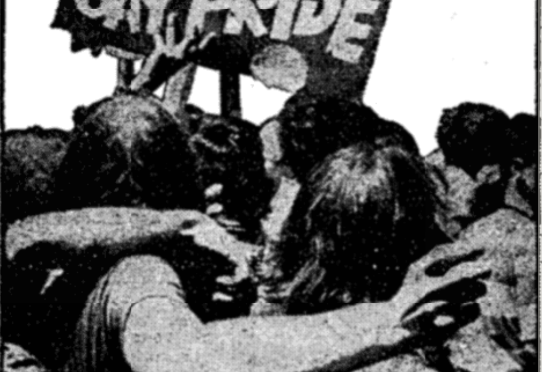 New York Times Image Caption: "Treading in the steps of all the other miniroity groups that have been pressing their demands with demonstrations, homsexuals held a mass parade in New York last week to protest the discriminations they suffer." Photo: Grainy black and while photo of people hugging, a sign above reading "Gay Pride."